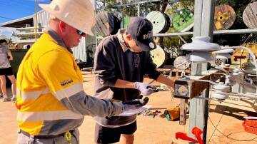 A student has a go on the tools at Ergon Energy's Mount Isa depot. Picture Ergon Energy
