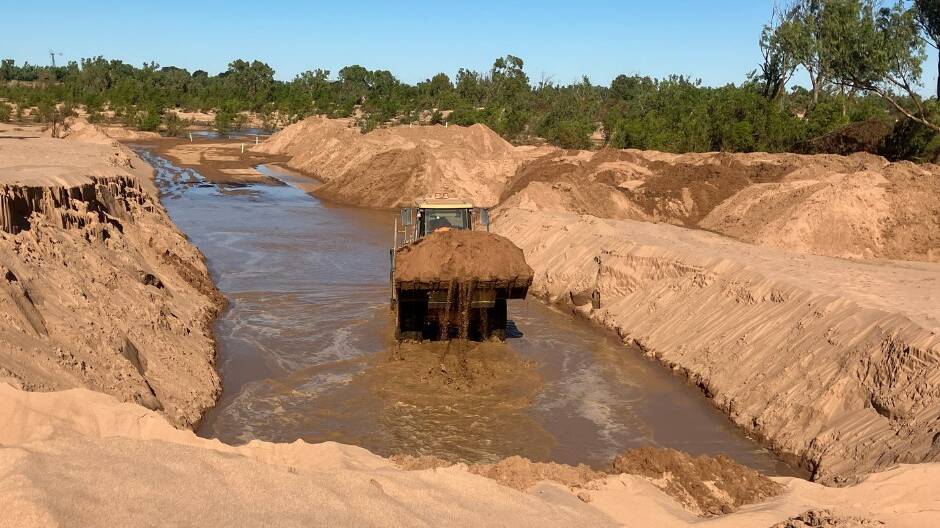 Burke and Carpentaria shires work together to remove sand from the Leichhardt River Crossing. Photo: Carpentaria Shire Council.