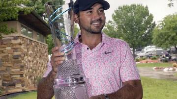 Jason Day, here with the Byron Nelson trophy in McKinney, Texas, is back to defend his title. (AP PHOTO)