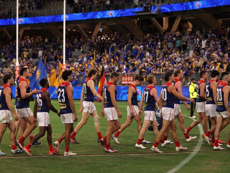 Frustrated Demons players leave the field after their humbling loss to the Eagles. (Richard Wainwright/AAP PHOTOS)