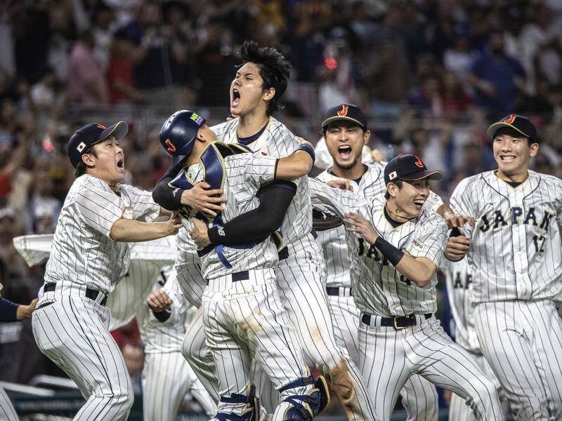 Munetaka Murakami of Team Japan reacts to hitting a walk off two