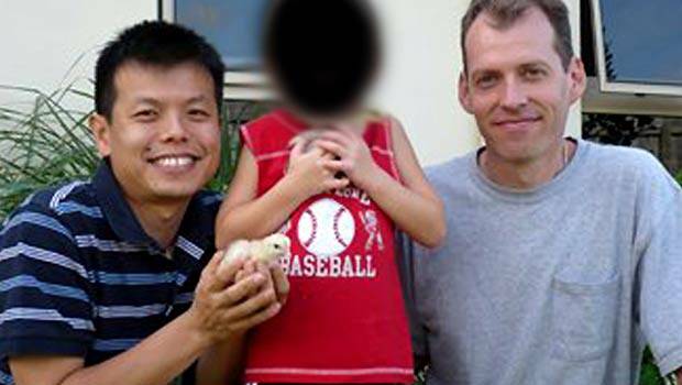 Double lives: Newton, right, with Truong and their son outside their Cairns home.